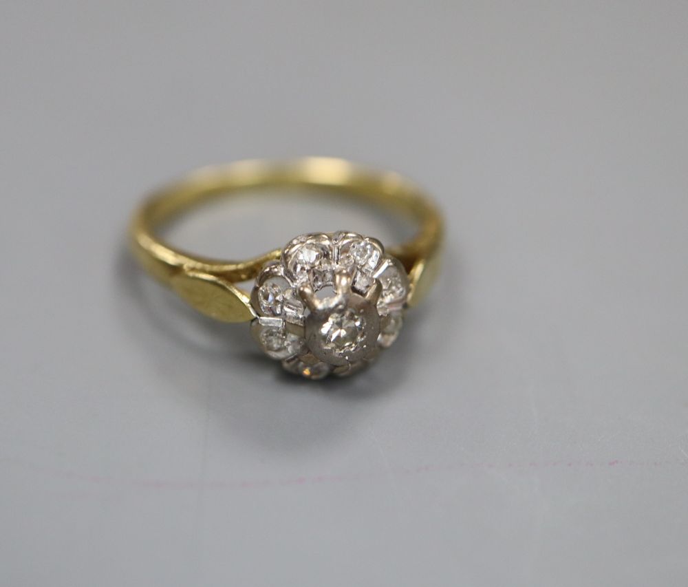 A modern 18ct gold and illusion set diamond cluster ring, size J, gross 3.4 grams.